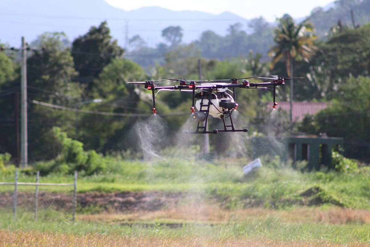 Spray drone applying product over a crop